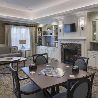 Cozy living room with a fireplace and a table set for games.