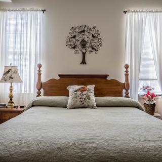 A cozy bedroom with elegant decor and soft lighting.