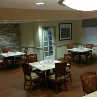 An empty dining area with neatly arranged tables and chairs.