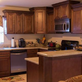 A cozy kitchen with wooden cabinets and modern appliances.