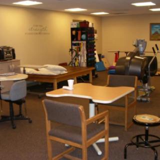 A rehabilitation center with exercise equipment and therapy stations.