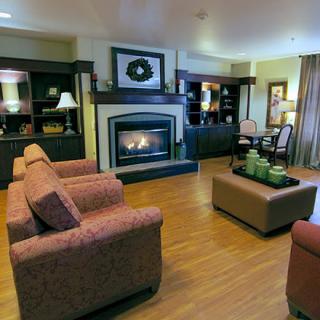 A modern living room with comfortable seating, a fireplace, and elegant decor.