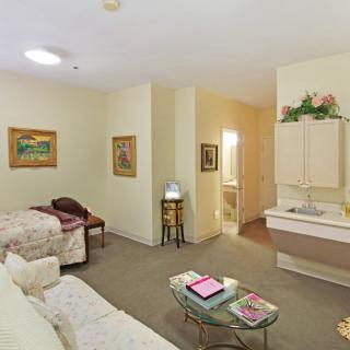 A cozy living space with a sofa, bed, and decorative elements.