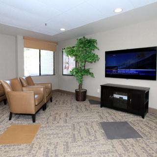 A modern living room with comfortable seating and a large TV.