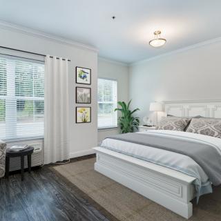 A modern and minimalist bedroom with elegant decor and a large window.