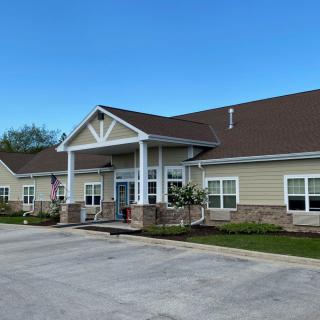 A suburban residential building with a prominent entrance and well-maintained landscaping.