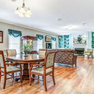 A spacious open-plan dining and living area with hardwood floors and elegant furniture.