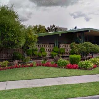 A well-maintained residence featuring a beautifully landscaped garden with vibrant flowers.