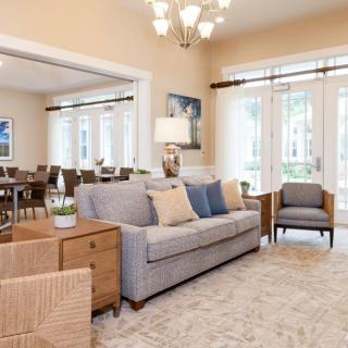 A spacious living and dining area with neutral tones and modern furniture.