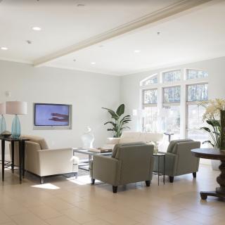 Modern living room with neutral tones and ample natural light.