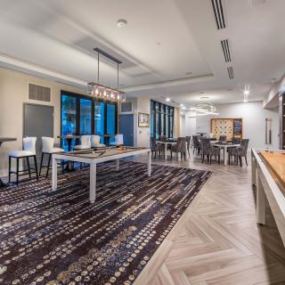A modern and spacious dining area with elegant furniture and lighting.