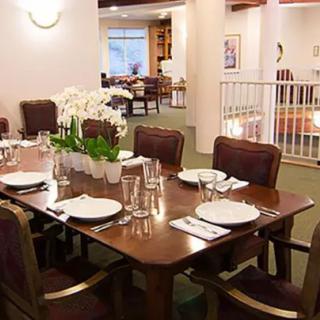 A well-set dining table in a restaurant with elegant decor and comfortable seating.