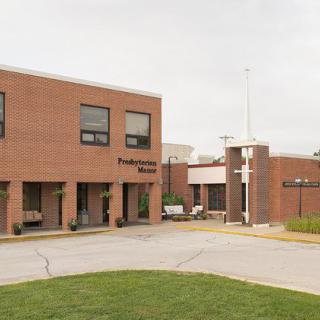 A brick hospital building with an entrance, photographed during the daytime.