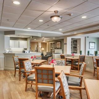 A modern and cozy dining area with neatly arranged tables and chairs.