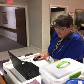 An employee working at a workstation in a healthcare facility.