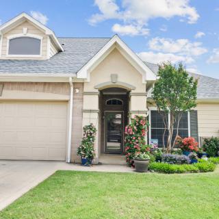 A suburban house with a well-maintained front yard and driveway.