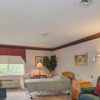 A well-lit hospital room with a bed, side table, and decorative elements.
