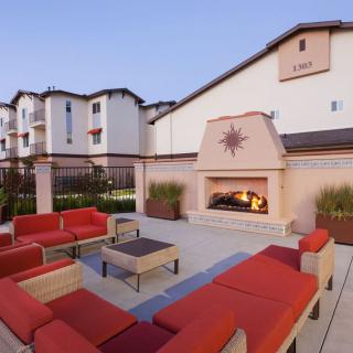 Outdoor seating area with a fireplace at a hotel.