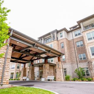 A modern residential apartment building with a covered entrance.