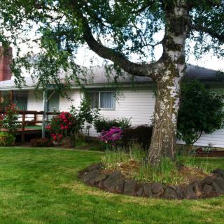 A charming residential house with a well-maintained lawn and garden.