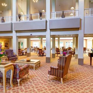 A spacious and elegantly furnished hotel lobby with high ceilings and comfortable seating areas.