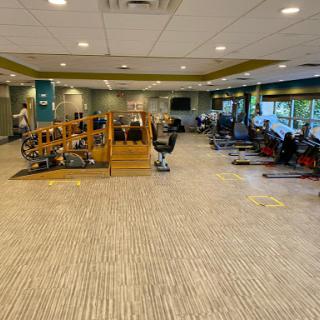 A spacious gym featuring various exercise equipment and areas for workouts.