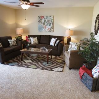 A cozy and inviting living room setup with comfortable seating and stylish decor.