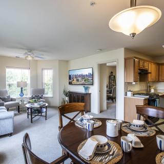 A modern open-concept living space featuring a comfortable living room, dining area, and kitchen.