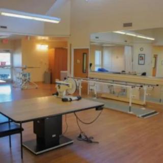 A physical therapy room equipped with various exercise tools and rehabilitation equipment.