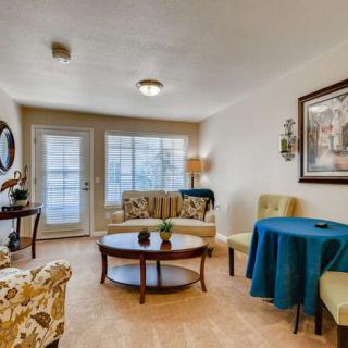 A cozy living room featuring elegant furniture, a round coffee table, and tasteful decor.