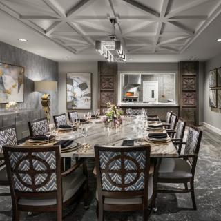 Elegantly designed dining room with a sophisticated table setting and artwork on the walls.