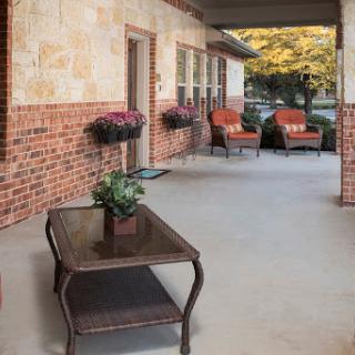 A cozy outdoor patio space featuring comfortable seating and decorative plants, perfect for relaxation.