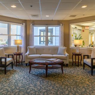 A cozy and inviting seating area with a couch and chairs, bathed in natural light.
