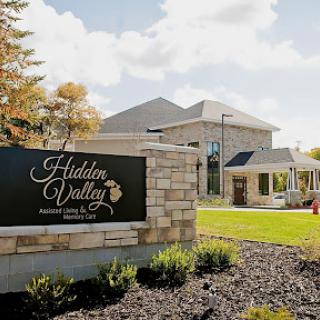 A view of the Hidden Valley building with a prominent sign in a landscaped outdoor setting.