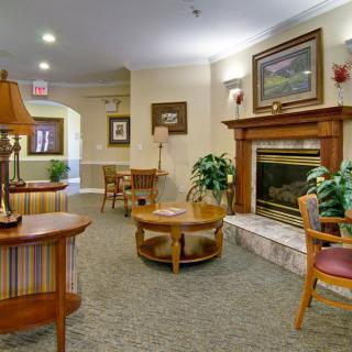 A cozy living room interior with a fireplace and comfortable seating.