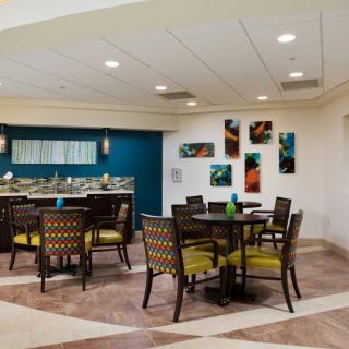 A modern dining area with stylish furniture and abstract artwork on the walls.