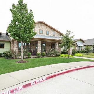 A suburban residential house with a well-maintained front yard and driveway.