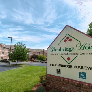 Cambridge House Senior Living community with a prominent entrance sign and surrounding landscape.