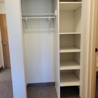 An empty closet with shelves, ready for organizing.