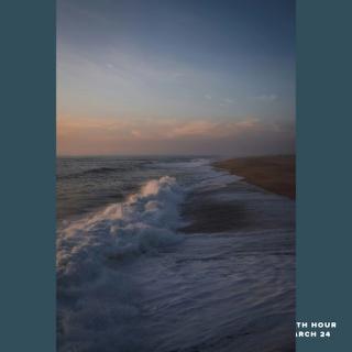 A tranquil sunset over the ocean, highlighting the gentle waves lapping at the shore.