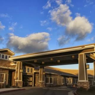 A beautiful residential building with a welcoming entrance under a picturesque sky.