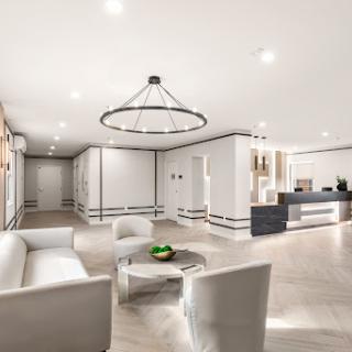 A modern and minimalist lobby design featuring a sleek seating area and contemporary lighting.