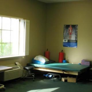 A simple room with a single bed and a poster on the wall.