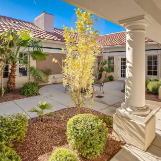 A beautifully landscaped courtyard featuring a mix of greenery and architectural details.