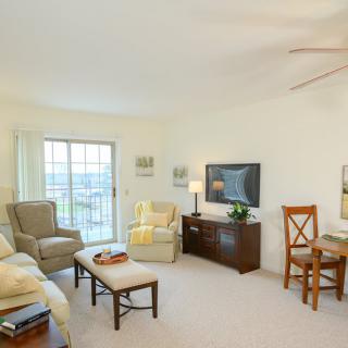 A cozy living room with comfortable seating, a TV, and a coffee table.