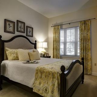 A cozy bedroom with elegant decor and warm lighting.