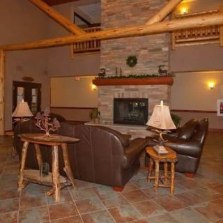 A cozy lobby with a rustic fireplace and comfortable seating area.