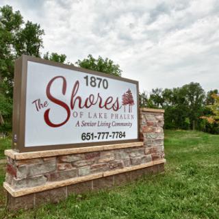 Entrance sign for The Shores of Lake Tairs, a serene community established in 1870.