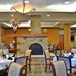 Luxurious restaurant dining area with elegant furnishings and a cozy fireplace.