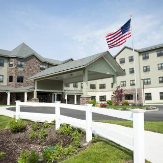 A hotel building with an American flag in the foreground.